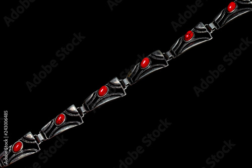 Silver pendant with gems on black background