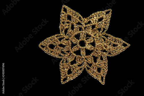 Gold Christmas snowflake isolated on black background
