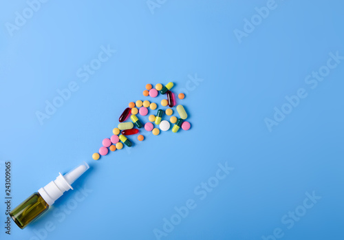 Pills capsules nose nasal spray medicine health on blue background top view, medical pharmacy concept photo