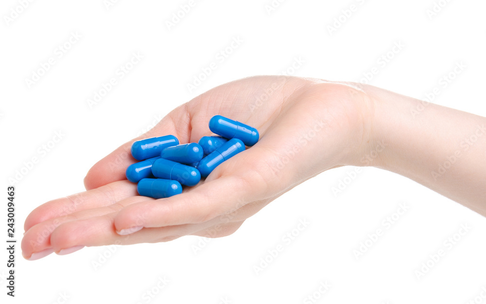 Pills capsules blue in hand medicine health on white background isolation Pills capsules blue in hand medicine health on white background isolation
