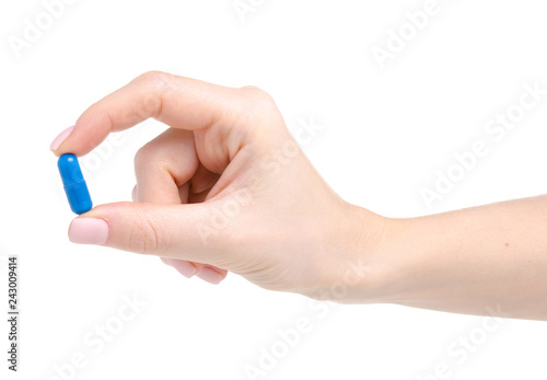 Pill capsule blue in hand medicine health on white background isolation