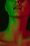 Young beautiful girl with green and red neon lighting