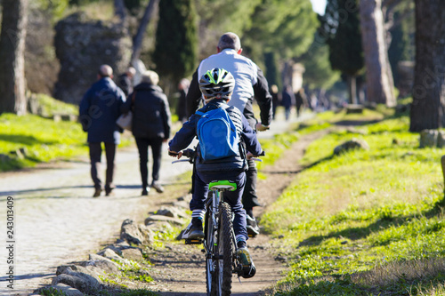 ciclisti e turisti in bicicletta lungo l'Appia Antica a Roma photo