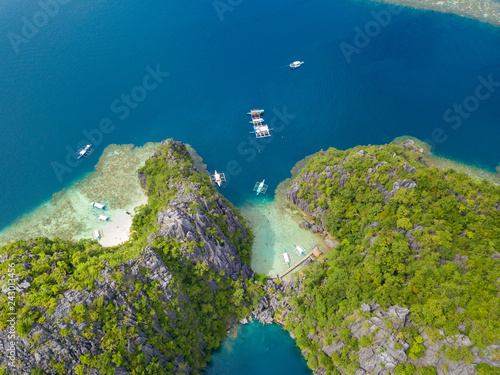 Aerial view to tropical lagoon with azure water and traditional sailing boat near Barracuda Lake, Coron island. Palawan, Philippines.