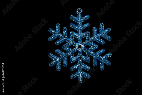 Christmas tree shining snowflake isolated on black background