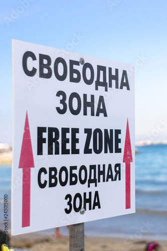 Free zone. Table on the beach. Seaside resort. Warning of free territory. Index of space for recreation. Inscription for vacationers.