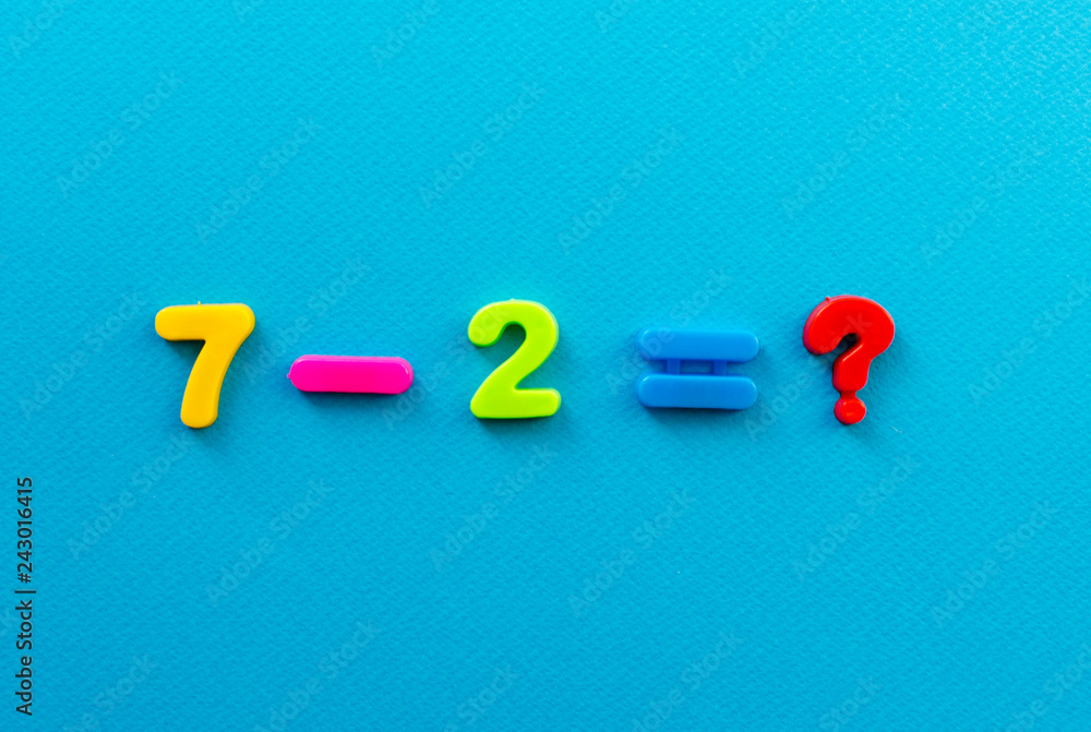 Naklejka premium math action from colored plastic numbers on blue paper background