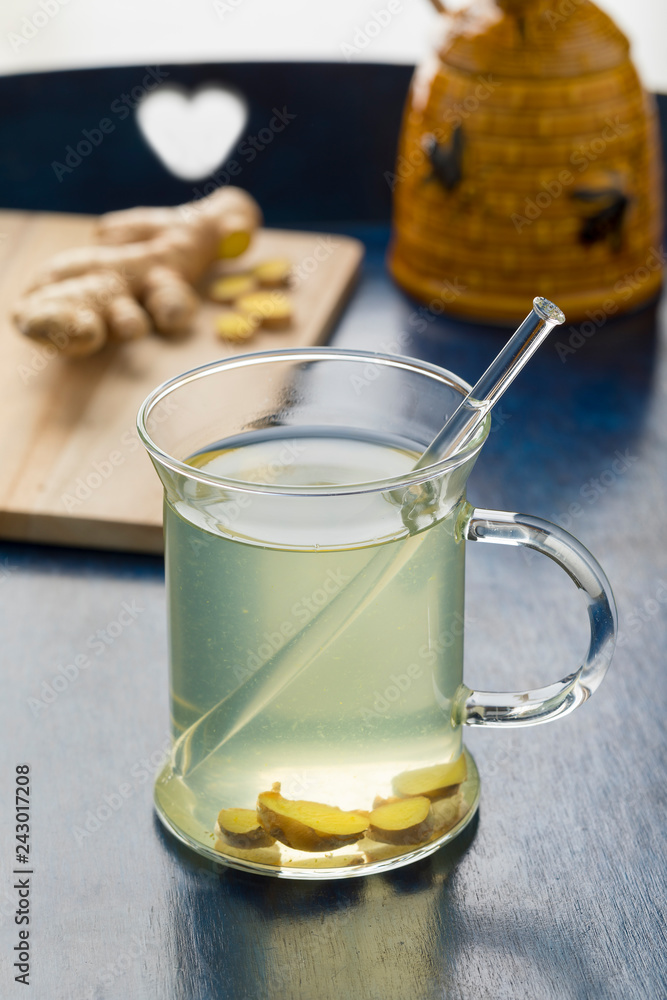 Glass cup with ginger tea and honey Glass cup with ginger tea and honey