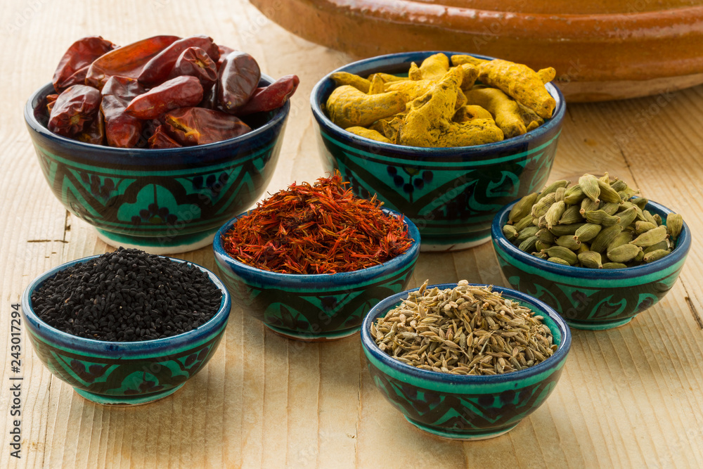Moroccan dried herbs in traditional bowls Moroccan dried herbs in traditional bowls