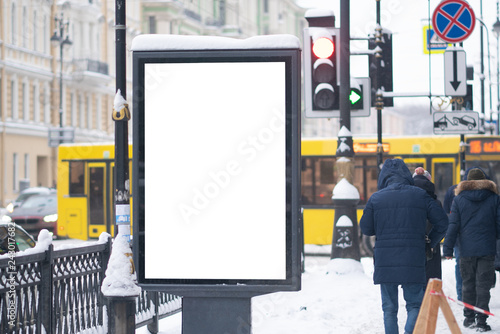 Outdoor advertising mockup. on the street of a winter city under the snow.