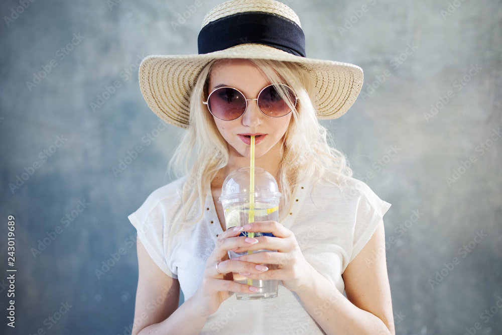 Young beautiful blonde woman in straw hat. Summer style sunglasses. Young beautiful blonde woman in straw hat. Summer style sunglasses.