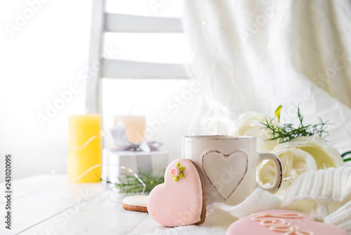 Heart cookies with cup of coffee on wooden background with plaid, copy space