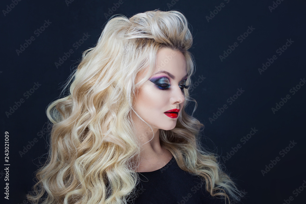 Portrait of a young luxurious blonde with long curls. Portrait of a young luxurious blonde with long curls.