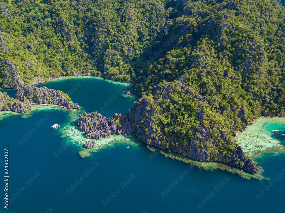 Aerial view to tropical Twin lagoon with azure water and traditional sailing boats, Coron island. Palawan, Philippines.