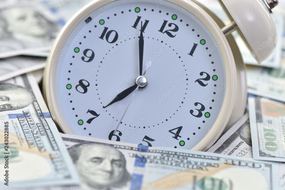 Time to make money. Alarm clock and dollars. Time to make money. Alarm clock and dollars.