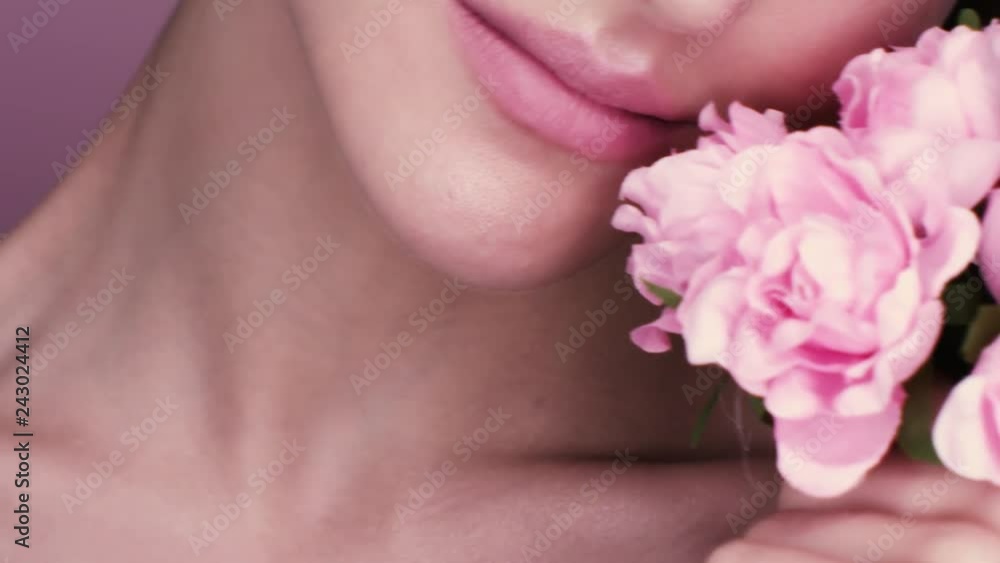 beauty portrait of a beautiful girl with makeup and flowers. closeup shot in studio on a pink background beauty portrait of a beautiful girl with makeup and flowers. closeup shot in studio on a pink background