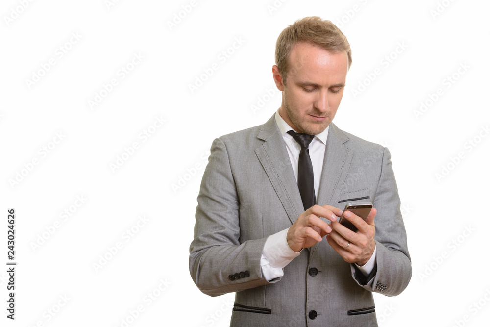 Handsome Caucasian businessman using mobile phone isolated against white background Handsome Caucasian businessman using mobile phone isolated against white background