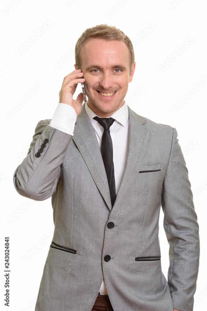 Happy Caucasian businessman talking on mobile phone Happy Caucasian businessman talking on mobile phone