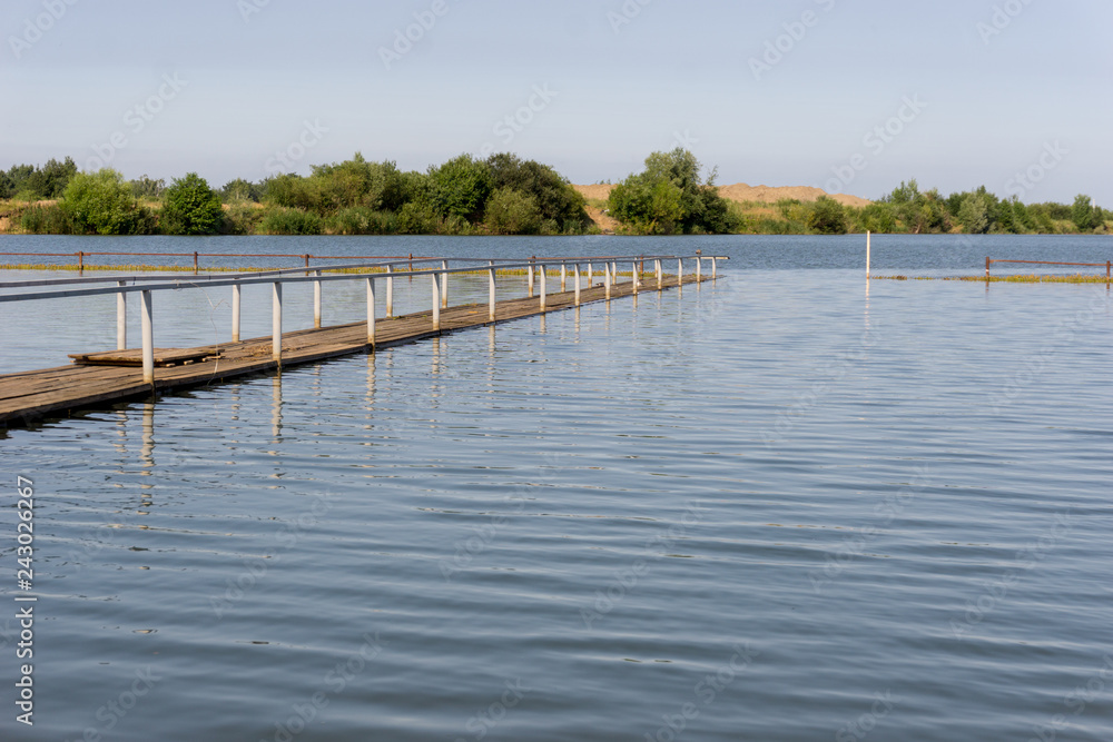 A wooden pier on the lake. A wooden pier on the lake.