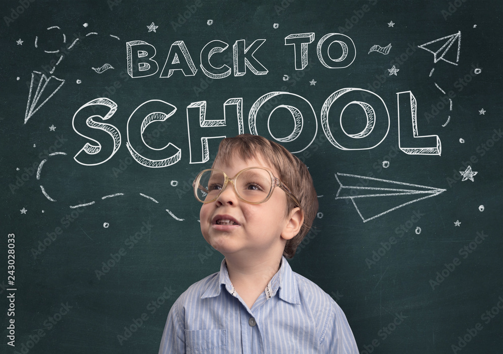 Adorable little boy with blackboard and back to school concept Adorable little boy with blackboard and back to school concept