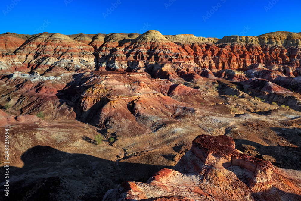 Rainbow City, Wucai Cheng. Colorful Red, Pink, Orange and Yellow landforms in a remote desert area of Fuyun County - Altay Perfecture, Xinjiang Province Uygur Autonomous Region, China. Rainbow Hills