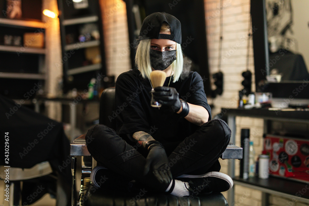 Girl sit on the chair and hold scissors in Barber Shop. - Image Girl sit on the chair and hold scissors in Barber Shop. - Image