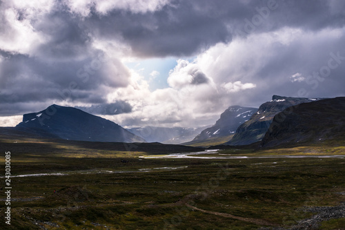 Valley and mountains at Kungsleden trail (Kings path) in northern Sweden during rain. 
