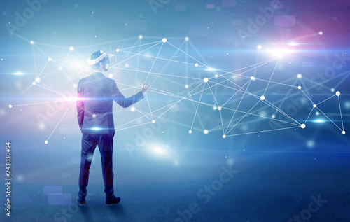 Young businessman standing with vj glasses and checking life-sized connectivity project  