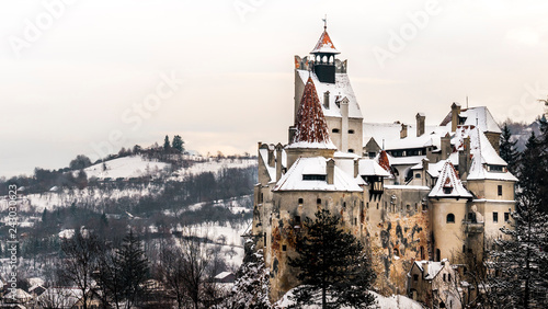 Bran Castle, Romania. Stunning view on a cold snowy day, twilight image of Dracula fortress in Transylvania, medieval landmark. Also know as Dracula`s house. photo