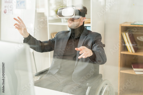 Businessman enjoying his experience in virtual reality glasses at office