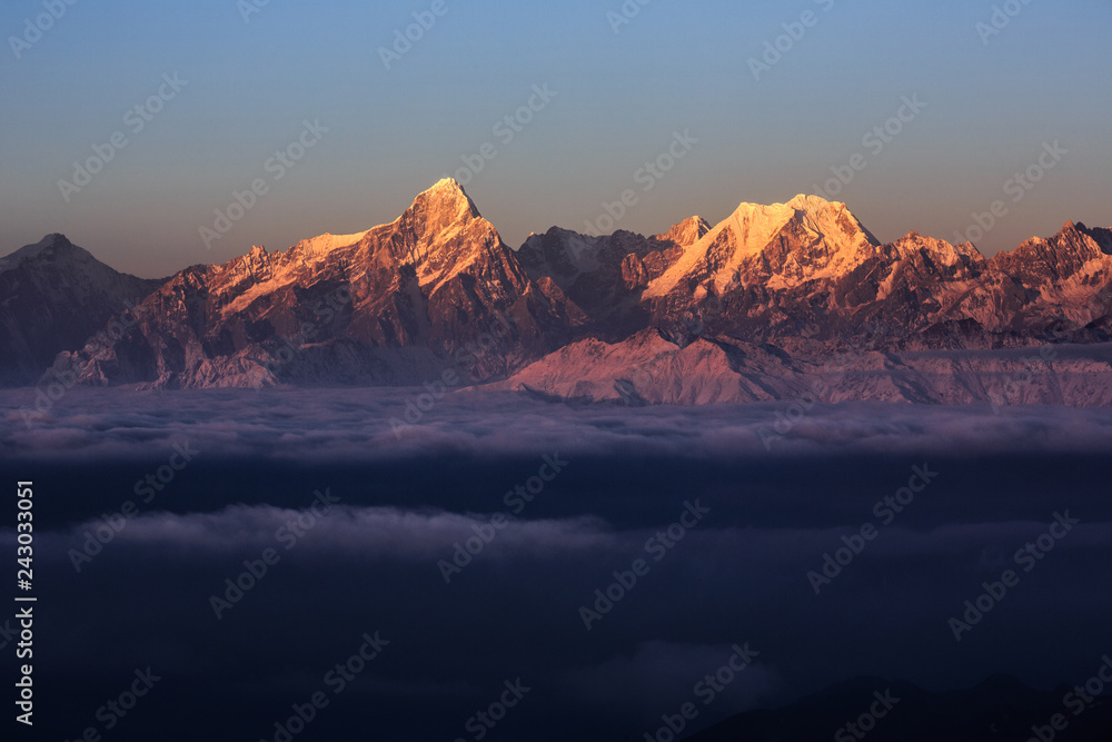 Niubeishan Landscape, Cattle Back Mountain in Sichuan Province China. Snow covered mountains, Ice Frost and Rime. Frozen Winter Landscape, Vibrant Purple Sunrise. Sea of Clouds, Gongga Mountain Range