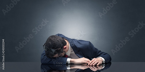 Young businessman fell asleep at his workplace with copy space