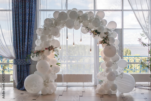 an arch of white balloons .
festive decor for the wedding.
decor of balloons and lights.
wedding background