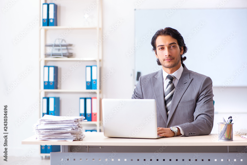 Young handsome businessman employee in the office Young handsome businessman employee in the office