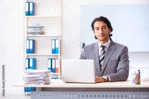 Young handsome businessman employee in the office 