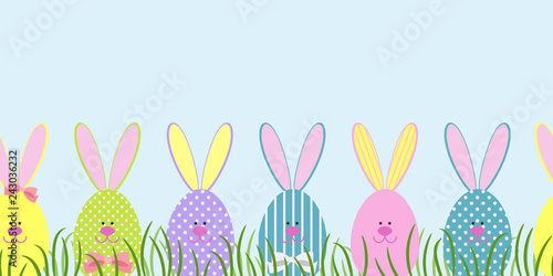 Seamless border with Easter bunnies in the green grass. Decorative Easter bunnies. Vector illustration