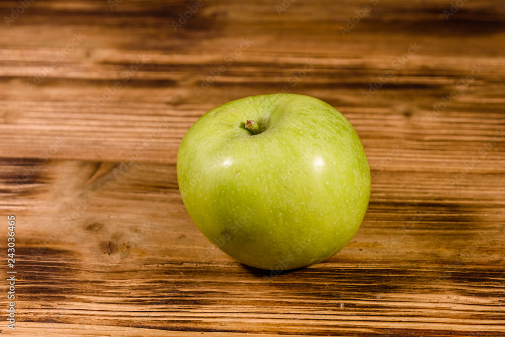 Ripe green apple on a wooden table Ripe green apple on a wooden table
