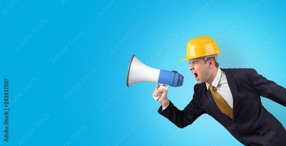 Young architect constructor yelling with megaphone and copyspace Young architect constructor yelling with megaphone and copyspace