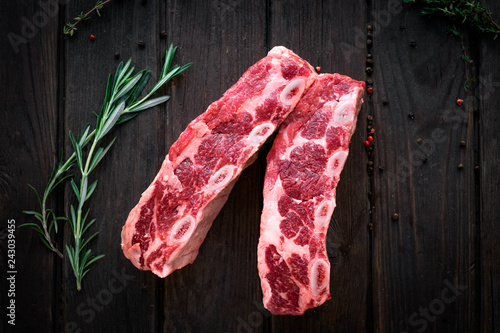 raw beef ribs kalbi on wooden background, top view photo