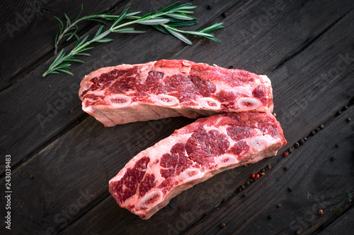 raw beef ribs kalbi on wooden background, top view photo