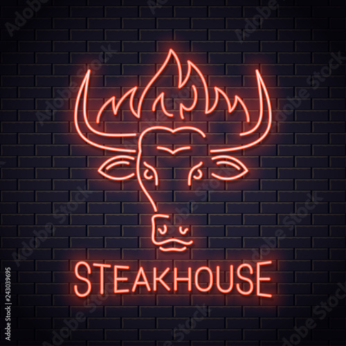 Bull head neon logo of steakhouse. Bull with fire