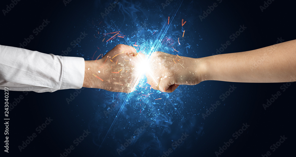 Two hands fighting with light, glow, spark and smoke concept
Two hands fighting with light, glow, spark and smoke concept