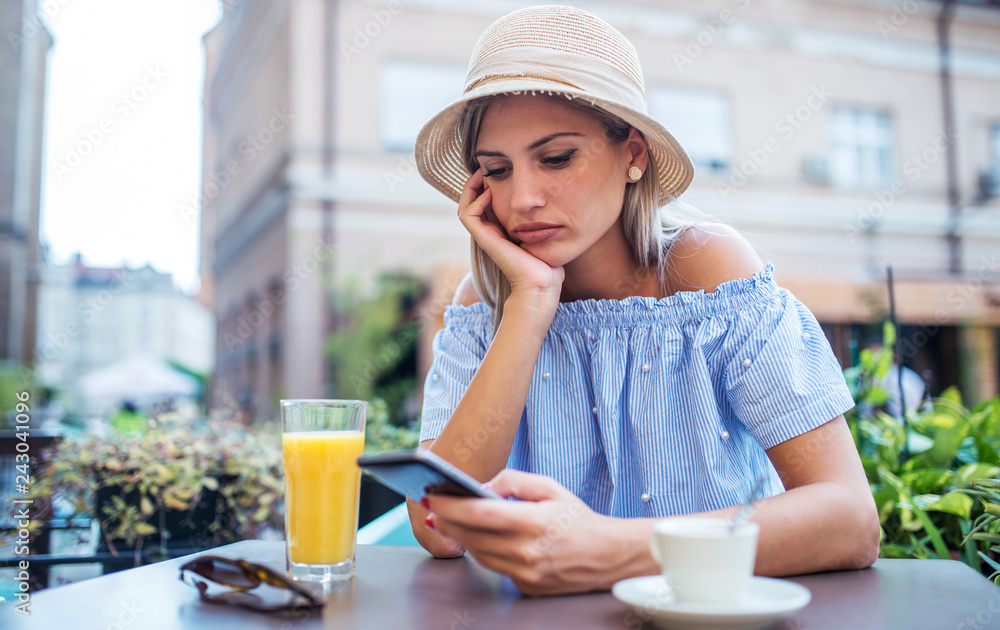 Attractive lonely woman sitting in a cafe and drinking coffee Attractive lonely woman sitting in a cafe and drinking coffee