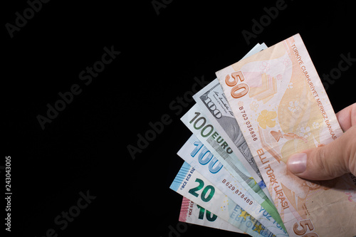 Hand holding American dollar  isolated on black background photo