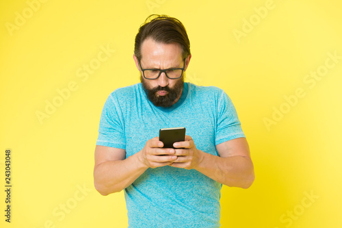 Hipster puzzled use smartphone. Man inexperienced user of modern smartphone. Stay in touch with smartphone. Join online community. User friendly concept. Man puzzled mobile phone opportunities © be free