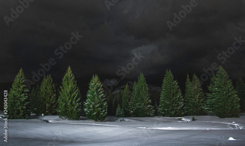 Snowfall on the mountains, dark and cloudy night