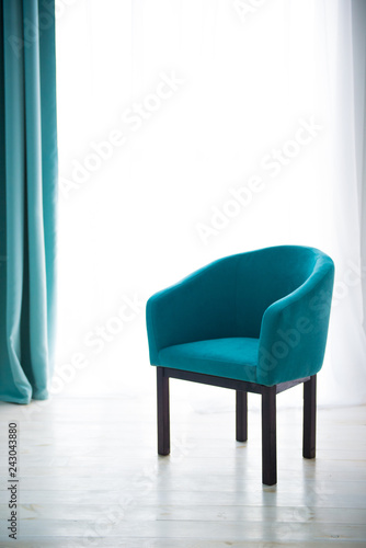 Blue chair against the window. The interior of the apartment