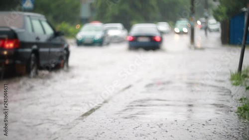 Car traffic on the flooded city street during heavy rain, heavy rainfall. Disaster flood, deluge. Water flow 