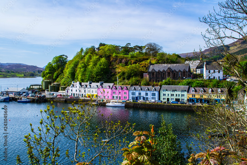Scenic landscape view of colorful buildings/houses in harbour of Portree town on Isle Of Skye in Scotland, United Kingdom. Popular tourist attraction/destination in Europe. Summer active holiday.