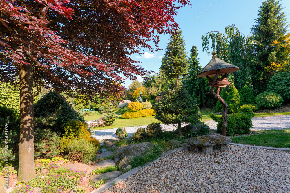 Beautiful spring garden, in front bird feeder, gardening concept Beautiful spring garden, in front bird feeder, gardening concept